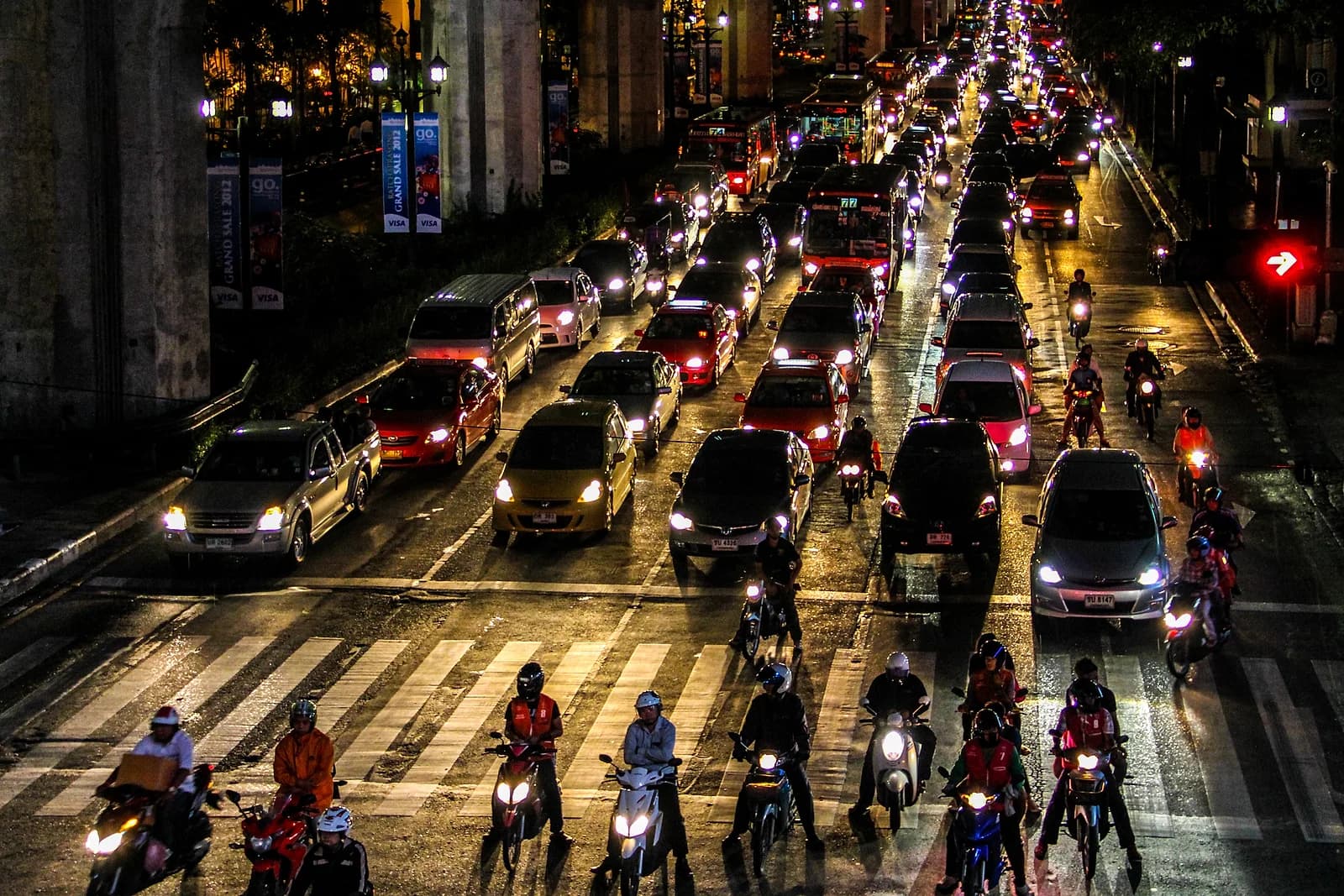 Motorbikes and taxis share the same late-night traffic across Bangkok's nightlife districts.
