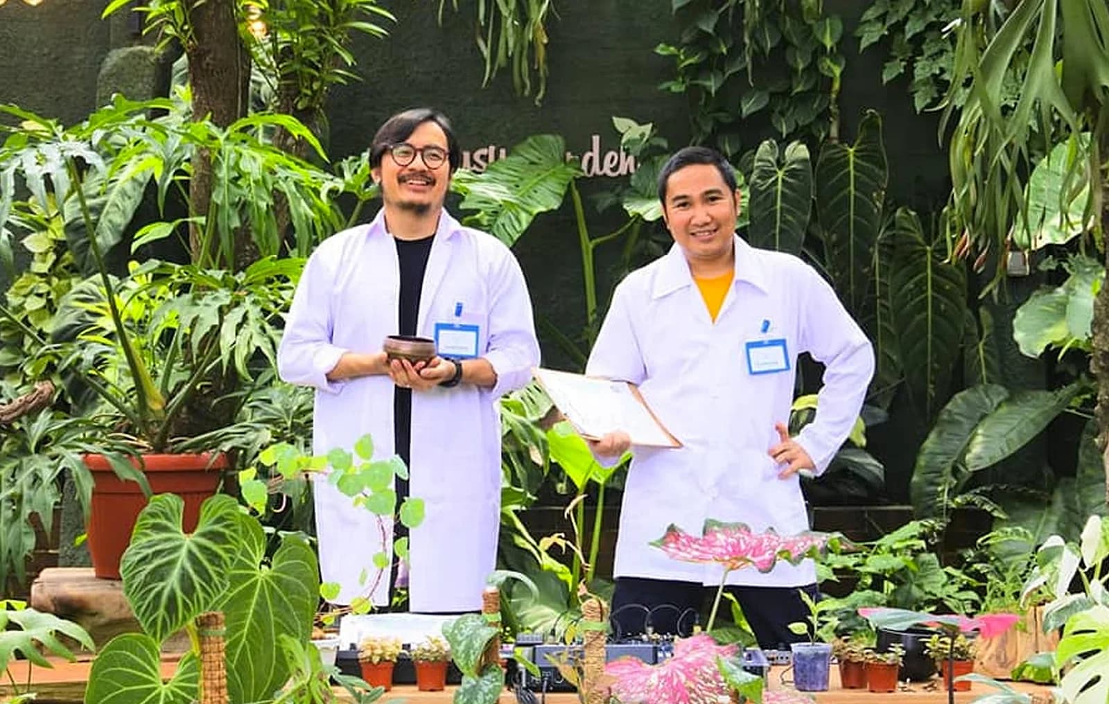 Angkuy (left) and Nobie mid-set at a 2021 Konser Plantasia performance, playing to a room of ferns and potted rice seedlings instead of a crowd.