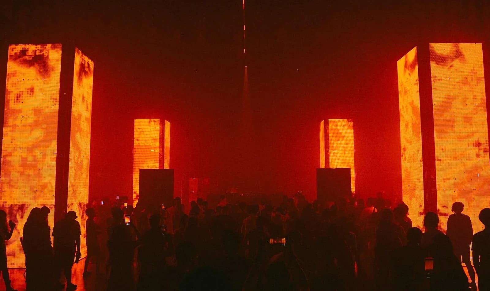Crowds move between glowing LED towers at a previous DIAGE edition. The 2026 edition adds a fourth zone, an Exhibition Zone featuring Fabrizio Di Salvo's work.