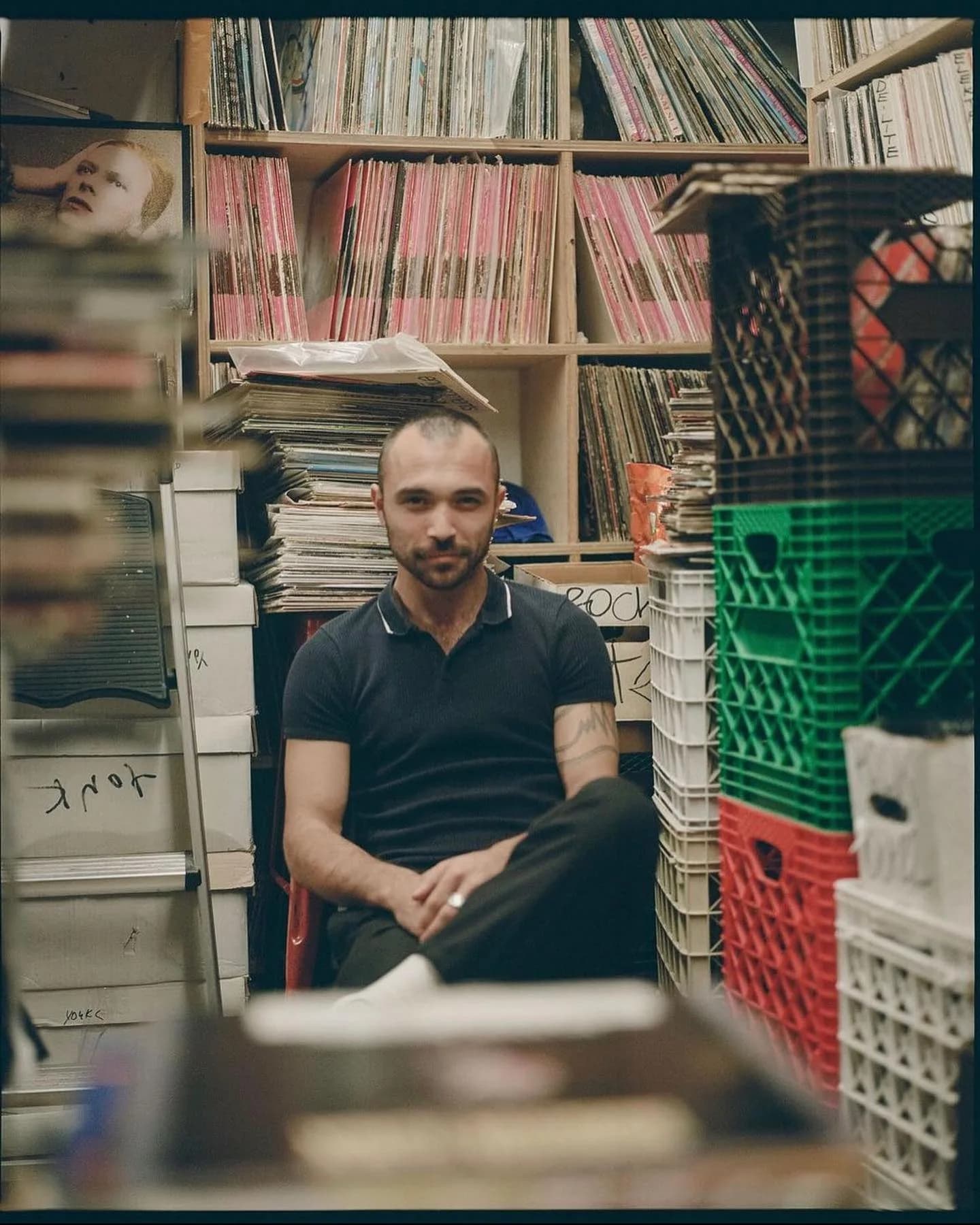 Crate-digging is still the day job. A Darker Than Wax member goes through stock at a New York record store, the label's jazz and soul roots on the shelves behind him.