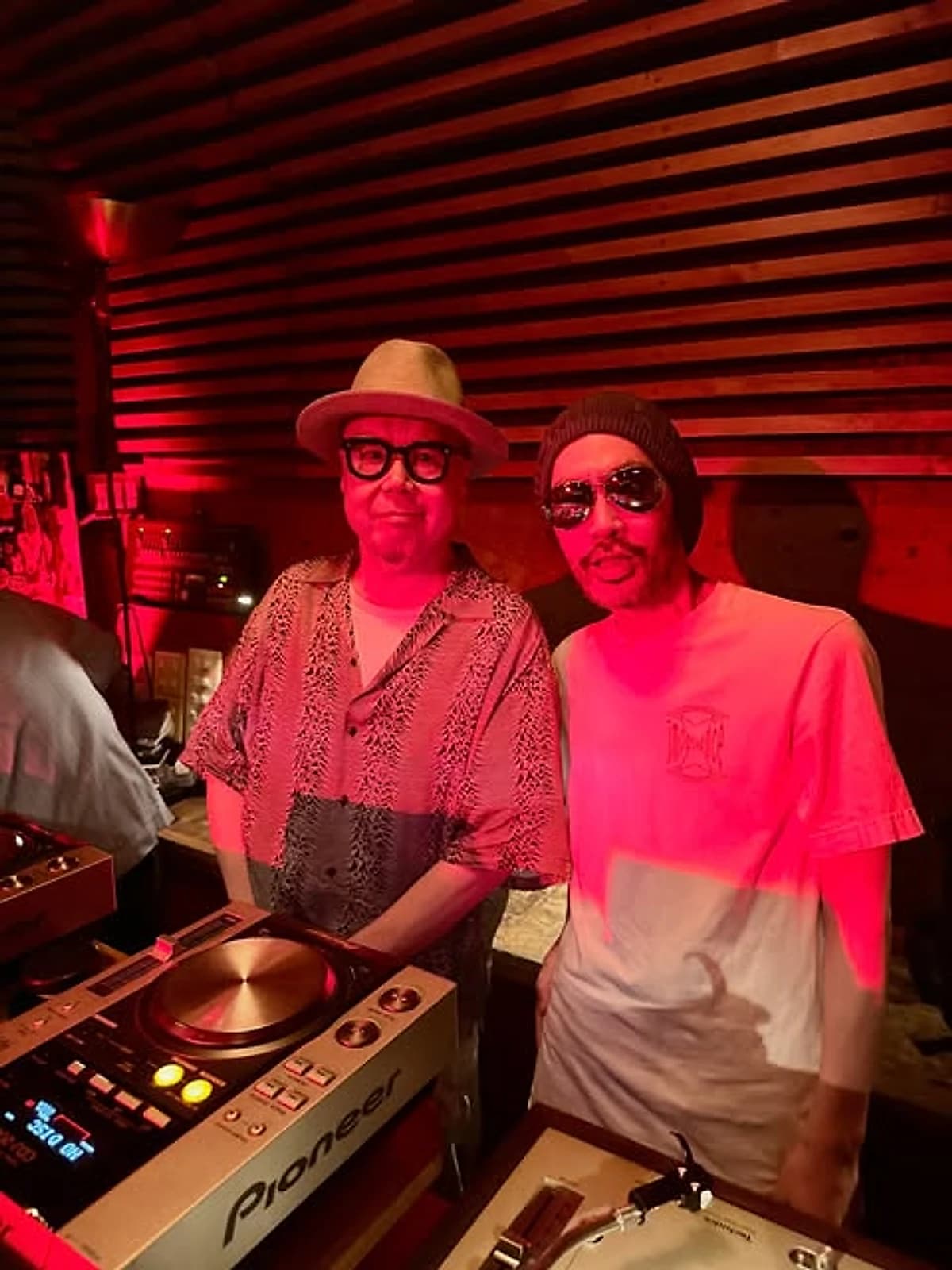 Hoshina Anniversary at a club gig in Tokyo, on the decks under red light.