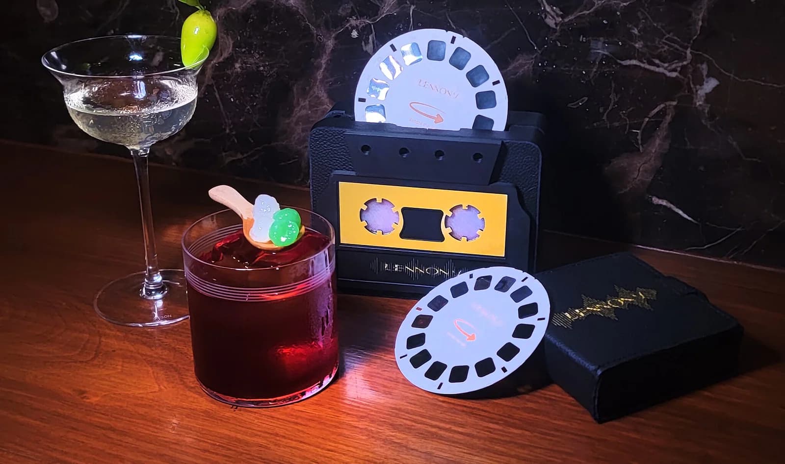 Lennon's own reel-to-reel and cassette props on the bar, alongside its Bangkok Beats cocktail menu.
