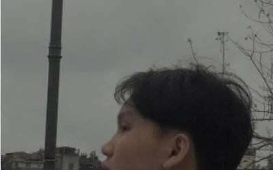 One of Mixtape 54's three members, photographed by the Hanoi waterfront.