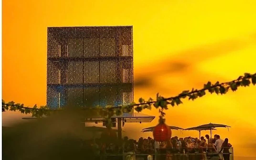 Savaya's clifftop cube at golden hour during People of the Sun, the venue's weekly Sunday series.
