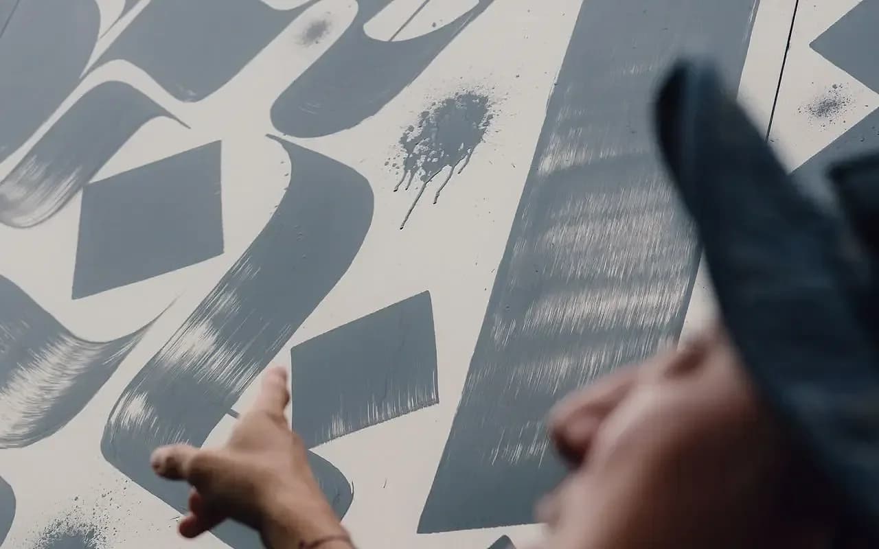 Rostarr, born Romon Kimin Yang, inspects a section of Evolving Landscapes mid-installation.