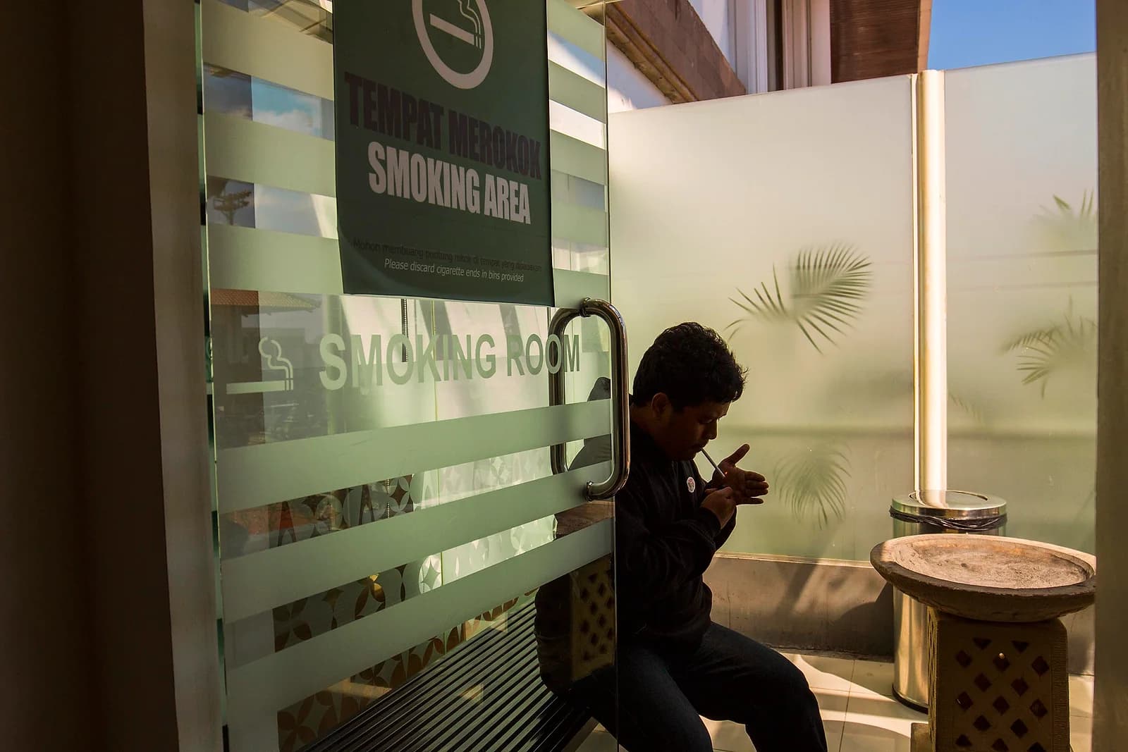 A designated smoking room at Bali's Ngurah Rai Airport. Indonesia regulates tobacco and vaping like any other consumer product rather than banning either.