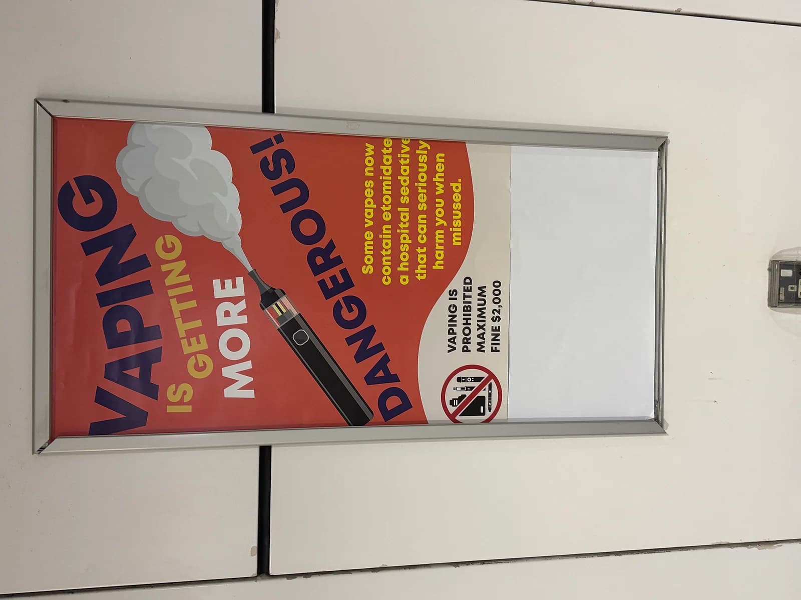 A public-health poster in Singapore's Maxwell MRT station warns that newer vapes can be laced with etomidate, a hospital sedative. The maximum fine printed on it, $2,000, is already out of date.