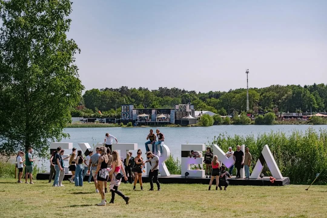 One of the seven Districts at XOBE, where forest clearings and open-air waterfront stages sit side by side across the De Plas grounds.