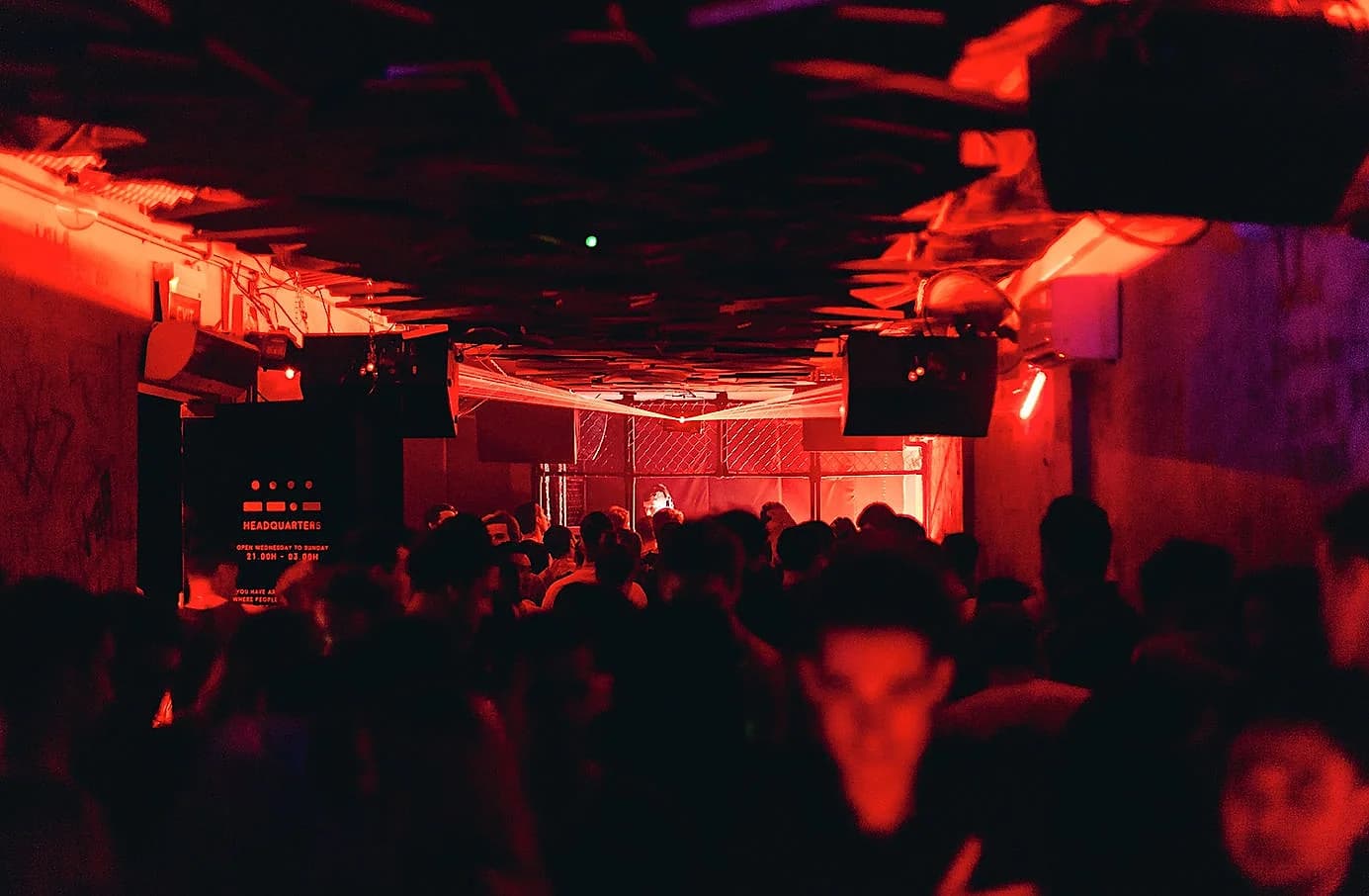Headquarters' caged booth and red-lit main floor, photographed before the club closed on May 30, 2026.