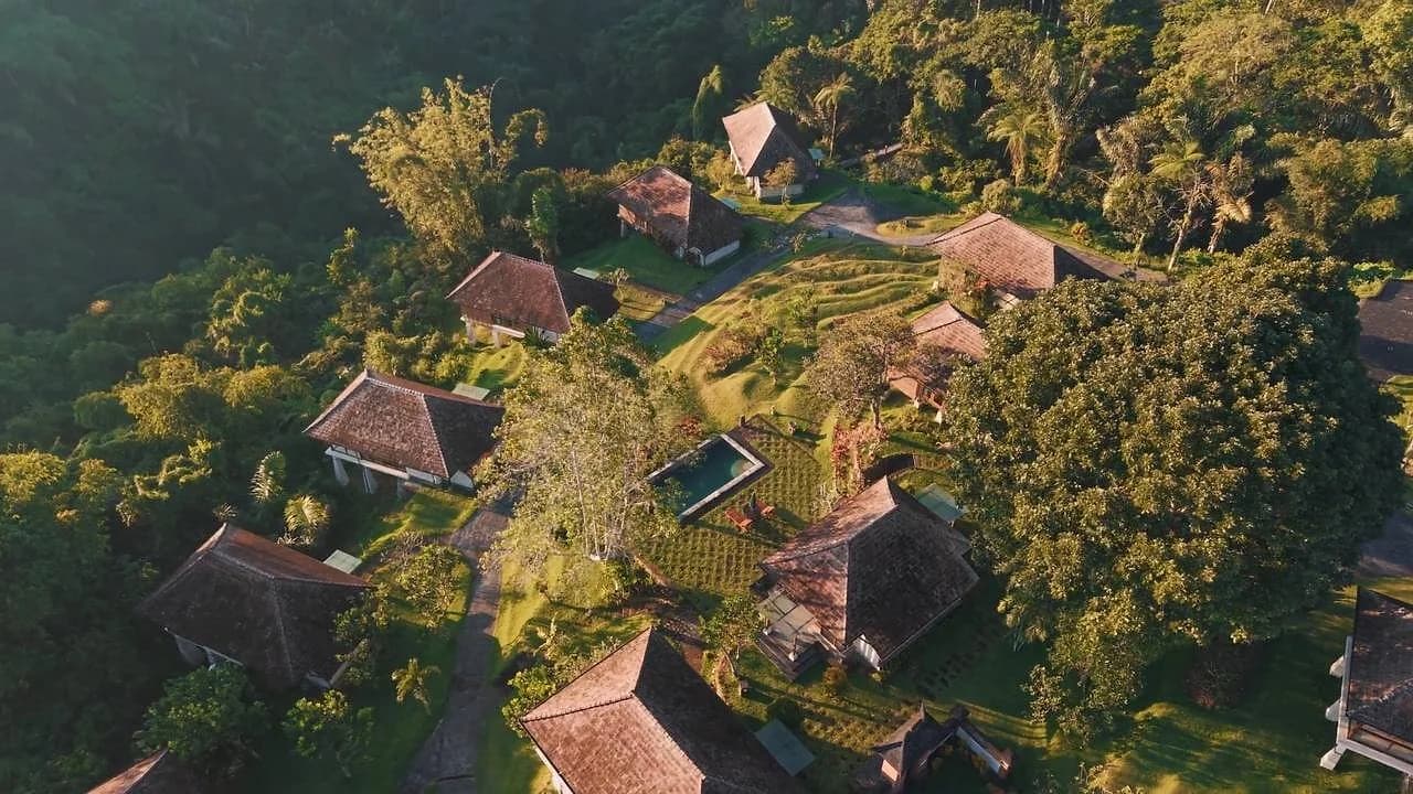 Bagus Agro Pelaga's thatched-roof buildings and pool, seen from above. The 18-hectare eco-farm hosts 48 resort rooms plus an on-site campsite for the weekend.
