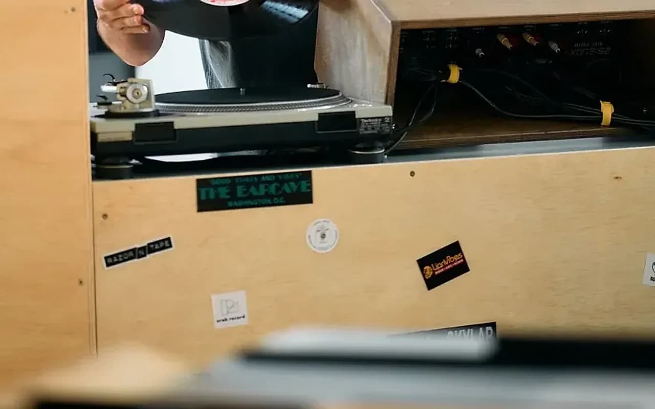 The listening corner behind the counter, a pair of Technics decks and stickers from record shops and labels Glick has crossed paths with over two decades.