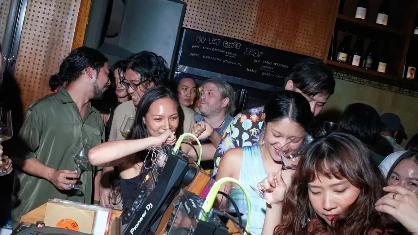 A full house crowds the decks at Salon Kiku, wine glasses in hand, vinyl crates stacked by the Pioneer gear.