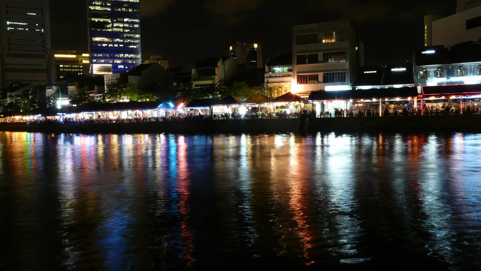 Boat Quay's riverside bar strip at night, a few minutes' walk from where Headquarters used to run.