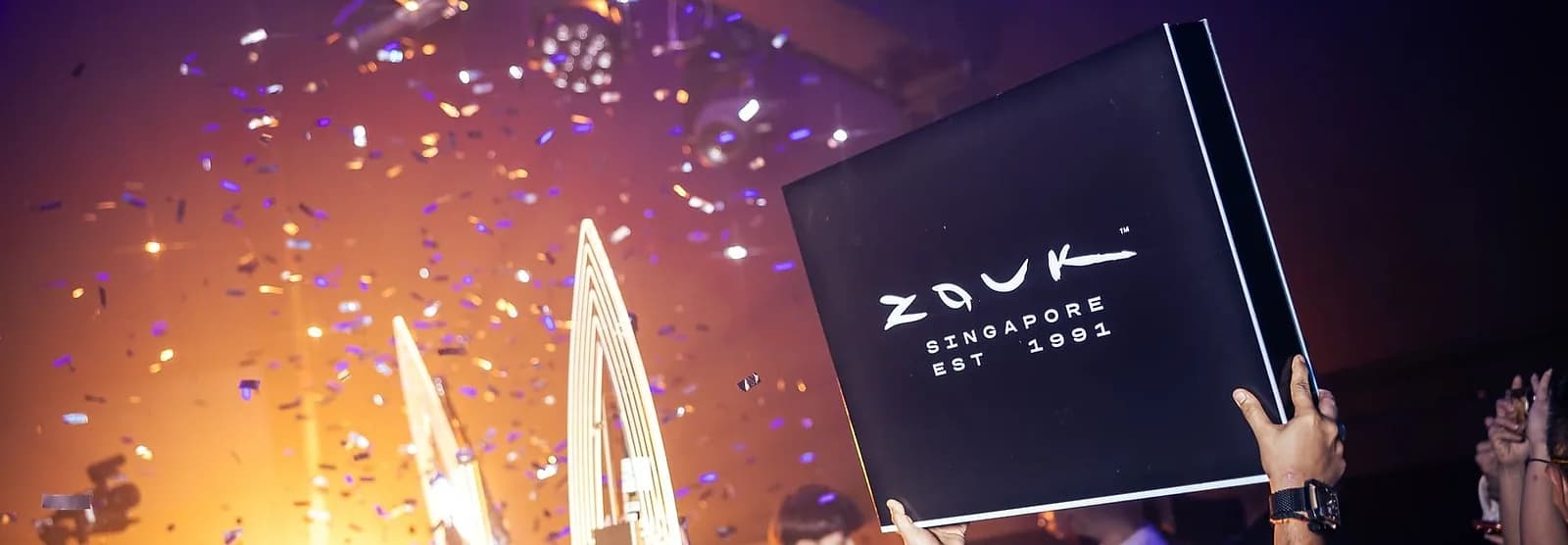 A table reservation at Zouk Singapore. The sparkler run and confetti are part of what you're paying for, not an extra.